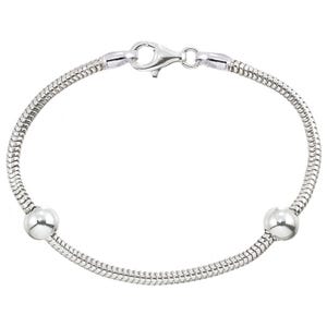 May include: A silver snake chain bracelet with two round silver beads. The bracelet has a lobster clasp.