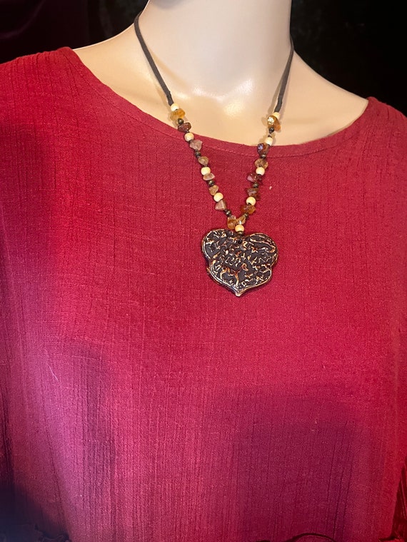 Plastic marbled heart with string and beads
