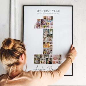 May include: A white framed photo collage of a baby's first year, with photos arranged in the shape of the number one. The text "My First Year" is at the top of the frame, with the date "August 23, 2024 | 12:00 AM | 7lbs 4oz" below. The baby's name "Amelia Davis" is at the bottom of the frame.