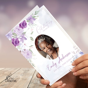 May include: A white and purple floral sympathy card with a gold border. The card features a photo of a woman in a circle and the text "Celebrating the life of Emily Anderson JULY 1946 - JUNE 22, 2023".