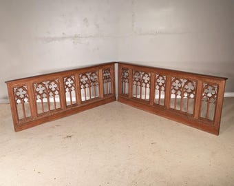 May include: A pair of L-shaped wooden architectural panels featuring intricate openwork carvings. Each panel displays a series of repeating arched window motifs with clover-shaped cutouts, finished in a warm, medium-toned brown wood grain.