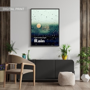 May include: A digital print with a quote that reads "Learn to dance in the rain" against a background of a blurry image of raindrops on a window. The image is framed in black.