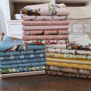 May include: A white ceramic mug with a black handle and the text "But First, Coffee" in a bold, black font. The mug is set against a blurred background, suggesting a cozy setting.