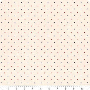 May include: Cream-coloured fabric featuring a repeating pattern of small red and navy blue polka dots. The dots are evenly spaced. A ruler at the bottom shows measurements in inches, equivalent to centimetres.