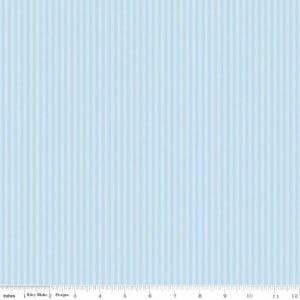 May include: Pale blue fabric featuring vertical stripes. The fabric has a subtle texture and a repeating pattern of light and slightly darker blue stripes. A ruler along the bottom edge shows measurements in inches.