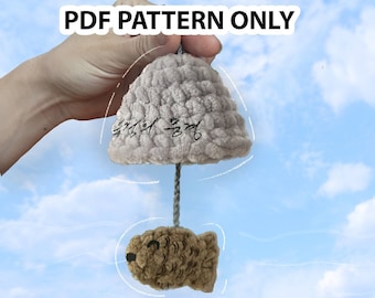 May include: A PDF pattern for a crocheted cloud-shaped toy with a fish hanging from it. The cloud is gray and has Korean writing on it. The fish is brown and has black eyes.