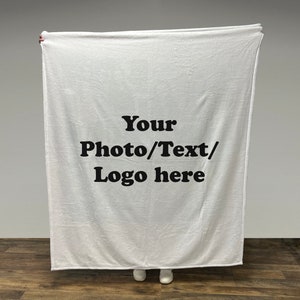 May include: A white fleece blanket with the text "Your Photo/Text/Logo here" printed in black.