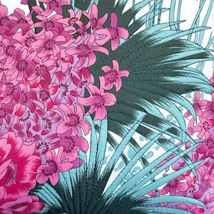 May include: A pink and white floral fabric with a green and blue leaf pattern. The fabric has a quilted texture.