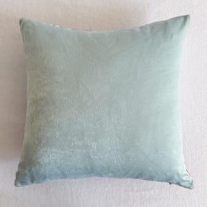 May include: A light blue cushion with a soft, textured fabric.