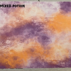 May include: A cross-stitch fabric with a blended design of orange, purple, and cream colors. The words "MIXED POTION" are printed in black at the top. The fabric has a grid-like texture.