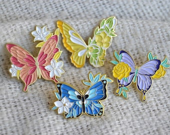 Pin / brooch / enamel badge in the shape of butterflies with various flowers and blossoms
