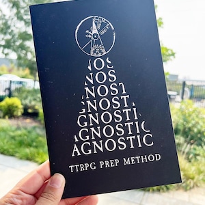 May include: A black card with white text and a circular graphic. The text reads "NOS, NOS, NOST, GNOSTI, AGNOSTIC, TTRPG PREP METHOD". The graphic is a compass-like design with the word "ORE" visible.