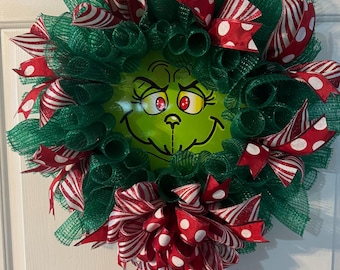 Christmas Green Monster Wreath! Cute green vinyl face! Green mesh with Red and white quality ribbons! 22 inches diameter! Free Shopping!