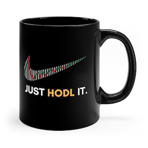 May include: Black ceramic coffee mug with a white Nike swoosh logo made of a stock chart pattern. The text "JUST HODL IT." is printed in yellow below the logo.