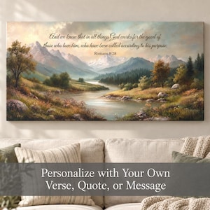 May include: A rectangular wall art canvas featuring a landscape painting of a river flowing through a valley with mountains in the background. The text reads: And we know that in all things God works for the good of those who love him, who have been called according to his purpose. Romans 8:28.
