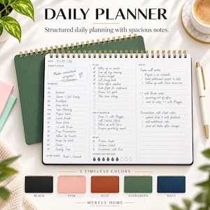 May include: A spiral-bound daily planner with a dark green cover, featuring a white interior page with sections for schedule, to-do lists, notes, meals, and a hydration tracker. The text reads Daily Planner, Structured daily planning with spacious notes, and Merely Home.