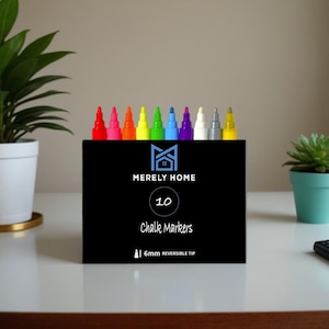 May include: A black box of 10 chalk markers with a reversible 6mm tip. The markers are arranged in a row, with vibrant colors including red, pink, orange, yellow, green, blue, purple, white, gray, and yellow. The box has the text "MERELY HOME" and "Chalk Markers".