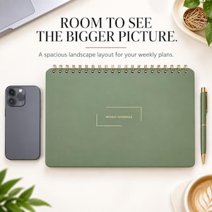 May include: A sage green landscape-oriented weekly planner with gold spiral binding and the text "WEEKLY SCHEDULE" in gold. The planner is accompanied by a dark gray smartphone and a matching sage green pen on a light surface.