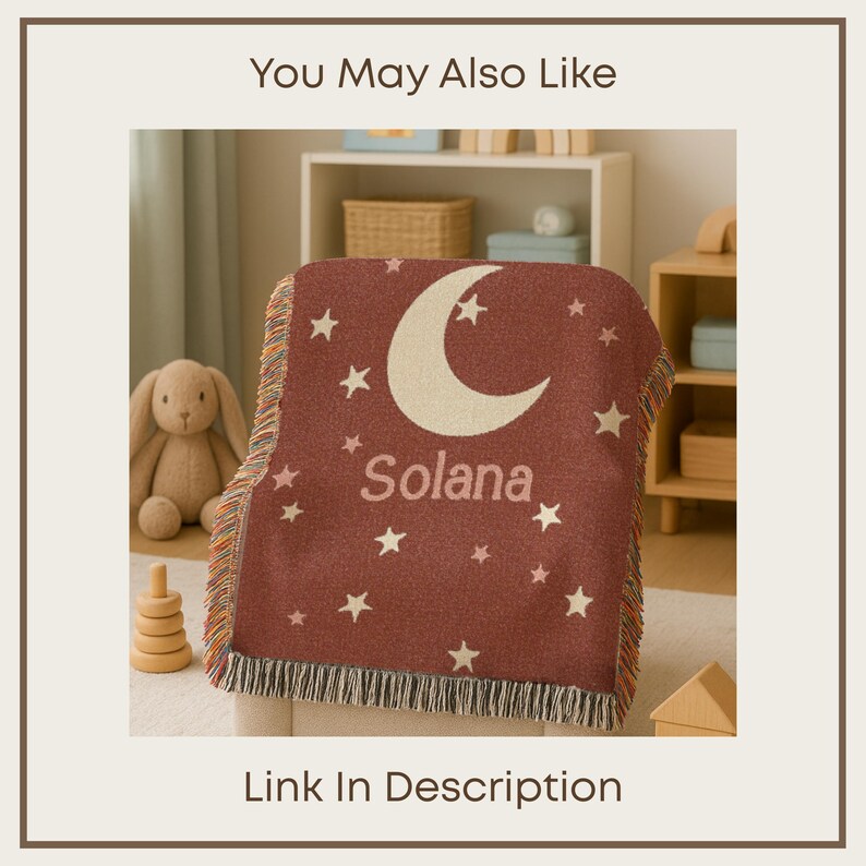May include: A maroon woven blanket with a cream-colored crescent moon and stars design. The name "Solana" is printed in cream-colored letters below the moon. The blanket has a fringed edge and is displayed on a chair.