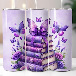 May include: A purple and lavender tumbler featuring a stack of books adorned with a large purple bow and butterflies. The design includes floral accents and geometric shapes, creating a whimsical and artistic aesthetic. The tumbler includes a straw.