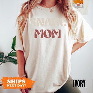 a woman with long blonde hair wearing a t - shirt