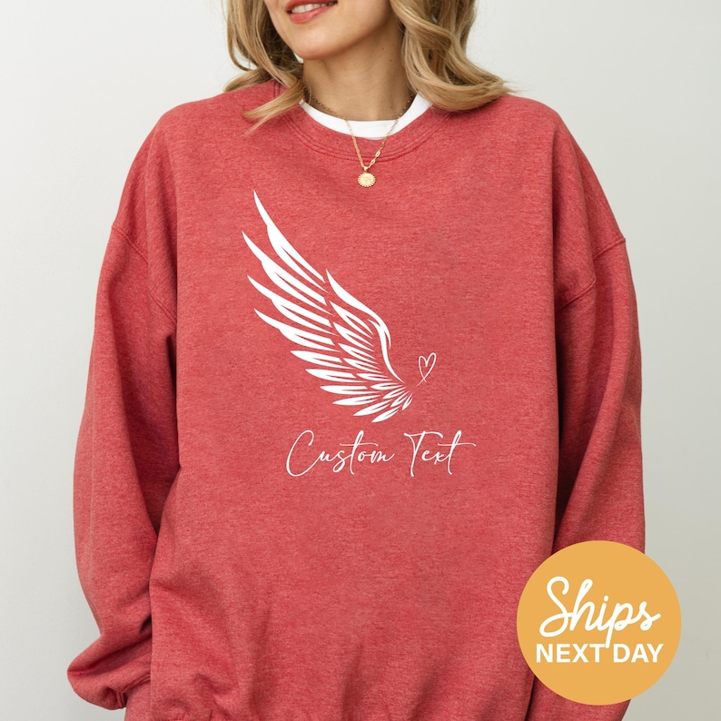 a woman wearing a red sweatshirt with a white bird on it