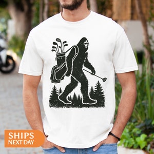 a man wearing a t - shirt with a bigfoot carrying a backpack