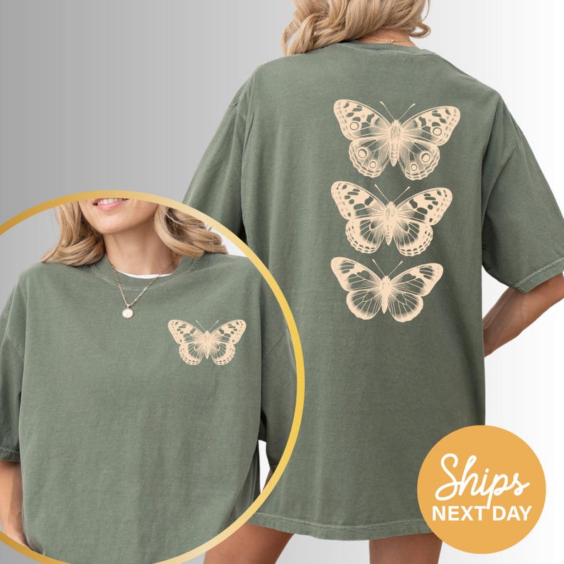 A woman wearing a green t-shirt with a graphic of three butterflies printed on the back.