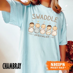 a woman wearing a swaddle t - shirt