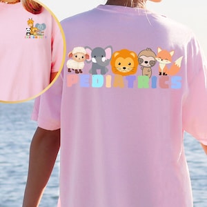 a person wearing a pink shirt with animals on it