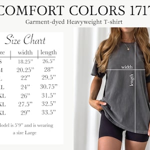 a woman wearing a gray shirt and black shorts