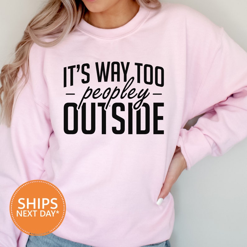 a woman wearing a pink sweatshirt that says it's way to people outside