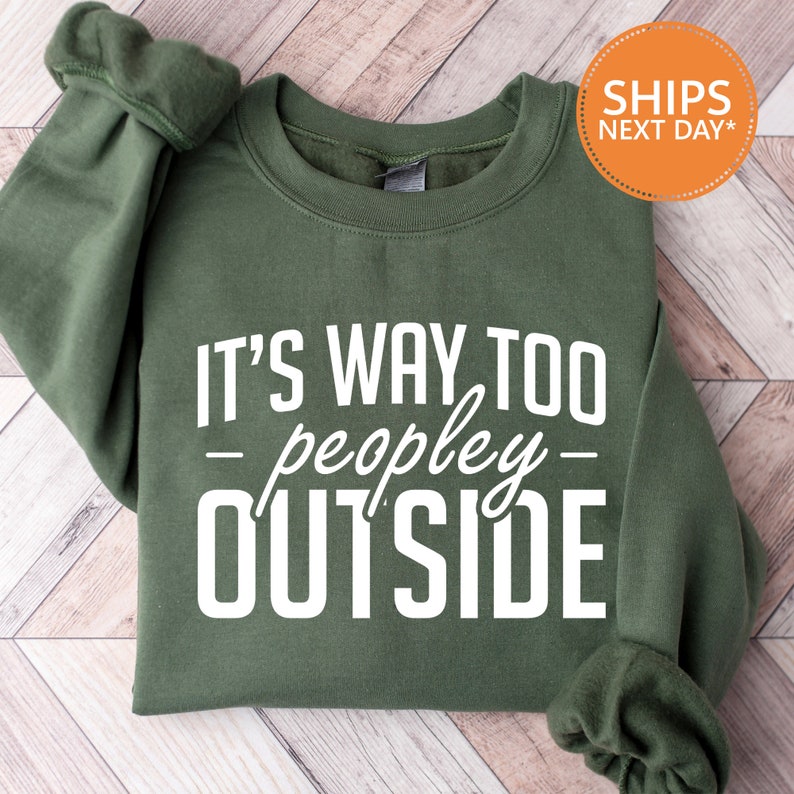 a green sweatshirt that says it's way to people outside