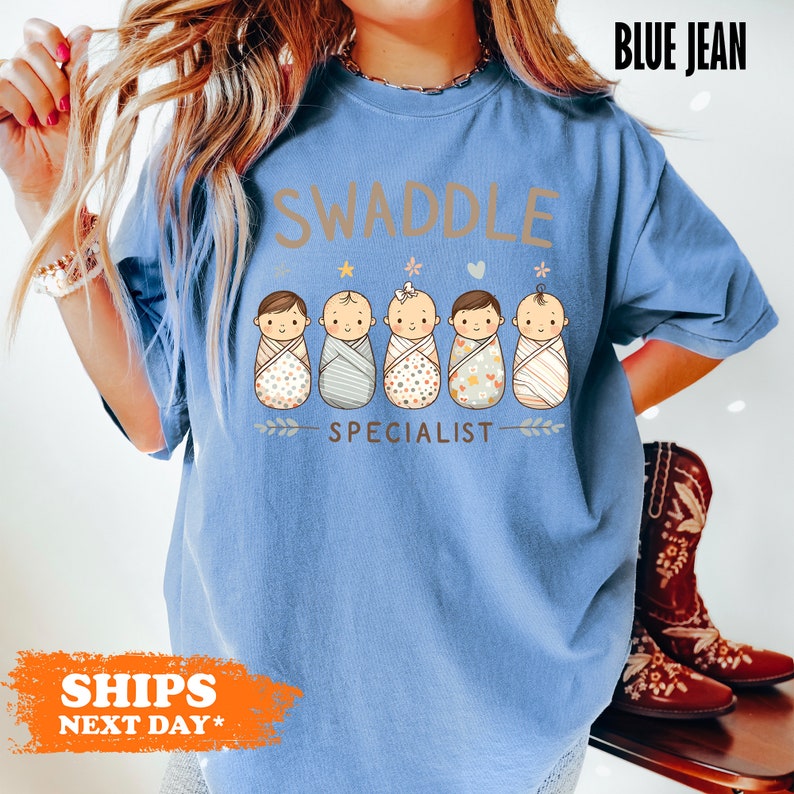 a woman wearing a blue tshirt that says swaddle special