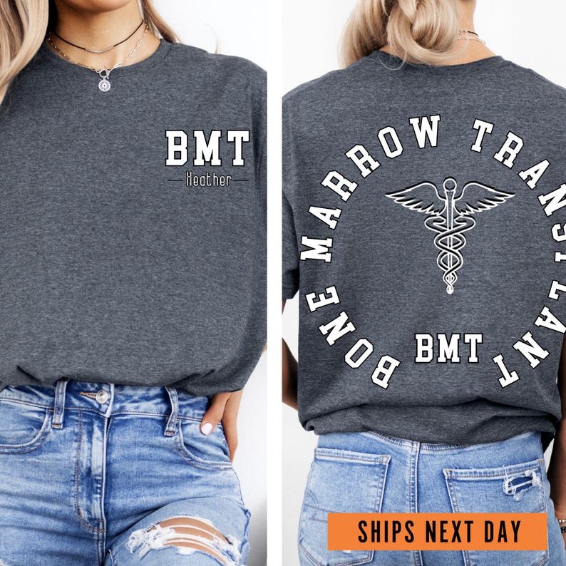 a woman wearing a gray t - shirt with a medical symbol on it