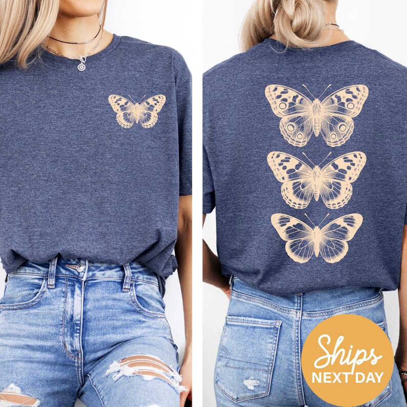 a woman wearing a blue t-shirt with a graphic of three butterflies on the back. She is also wearing distressed jeans.