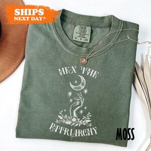 a green t - shirt with a picture of a woman on it