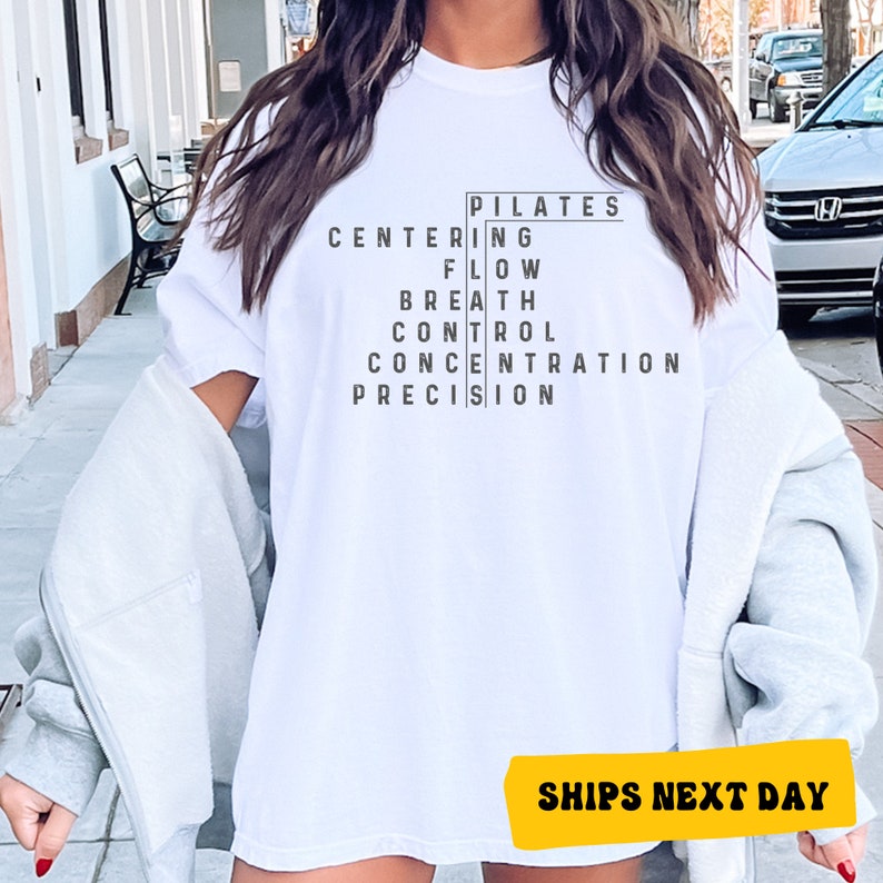 a woman wearing a white t - shirt that says pittales