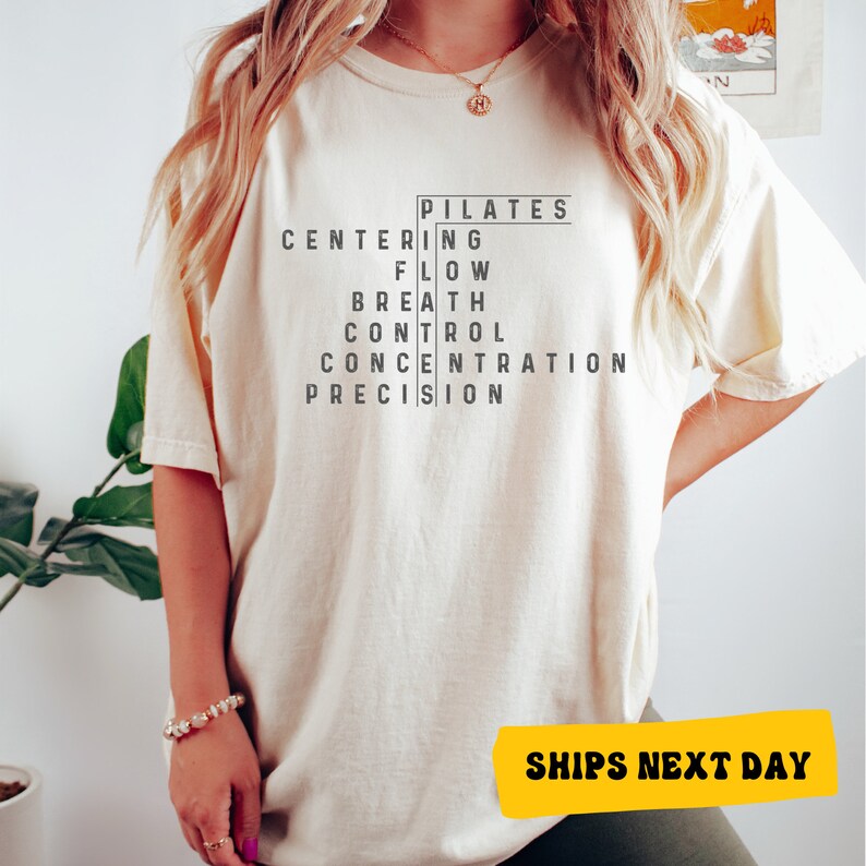 a woman wearing a white t - shirt with a black print on it