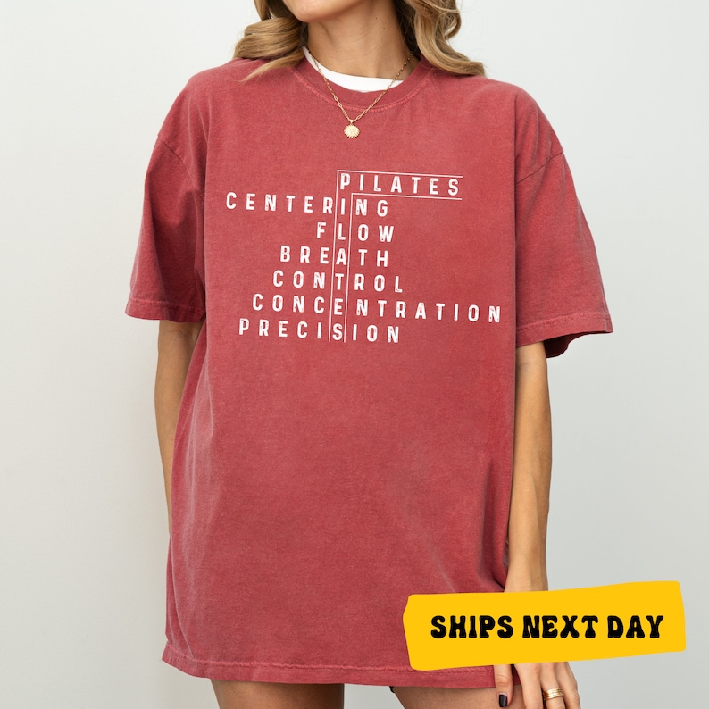 a woman wearing a red t - shirt with white writing on it