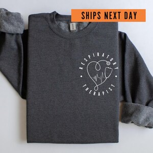 a gray shirt with a heart and heartbeat on it