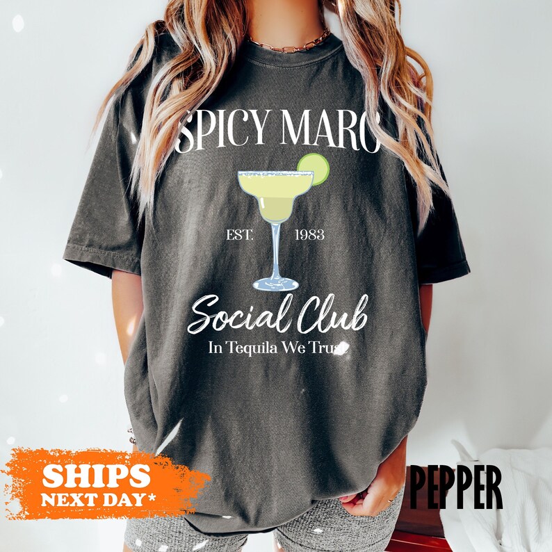 a woman wearing a t - shirt that says spicy marco social club in tequila we