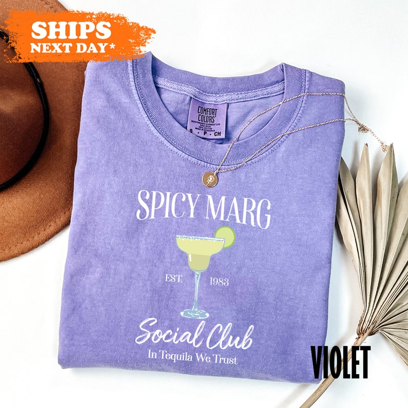 a purple t - shirt with the words spicy marg on it