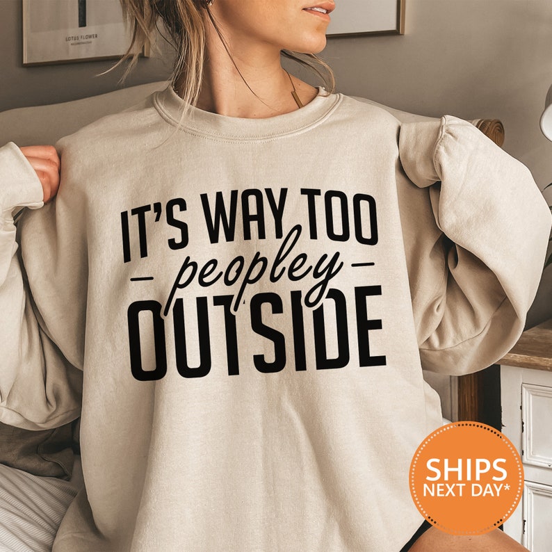 a woman wearing a sweatshirt that says it's way to people outside