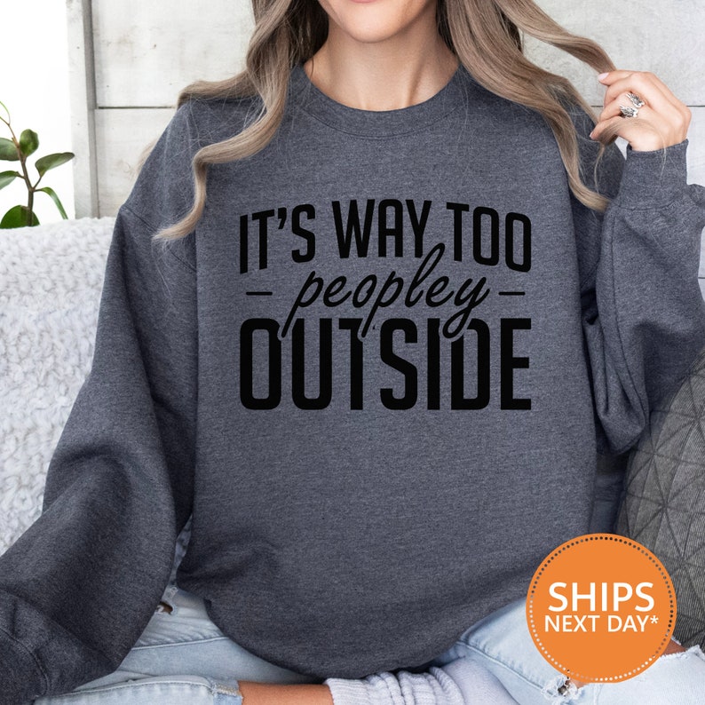 a woman wearing a sweatshirt that says it's way to people outside