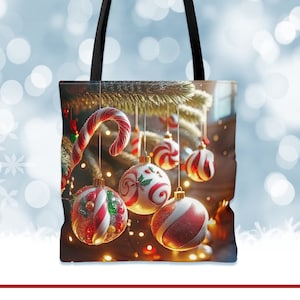 May include: A black tote bag with a Christmas tree design. The tree is decorated with red and white candy cane ornaments and red and white striped ornaments. The bag has a black handle.