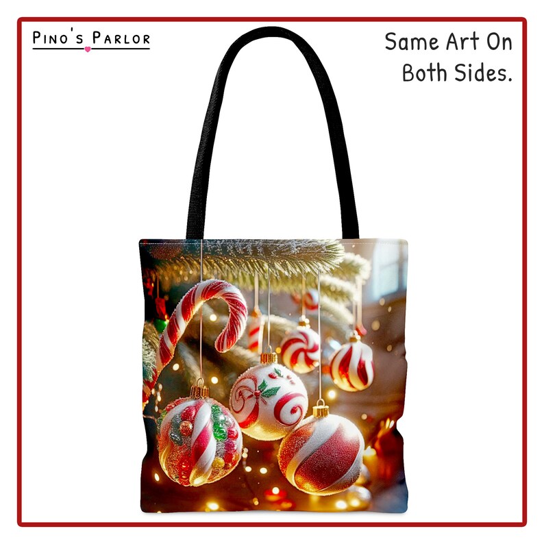 May include: A black tote bag with a Christmas tree design. The bag features red and white candy canes and ornaments hanging from the tree branches. The text "Same Art On Both Sides." is printed on the bag.