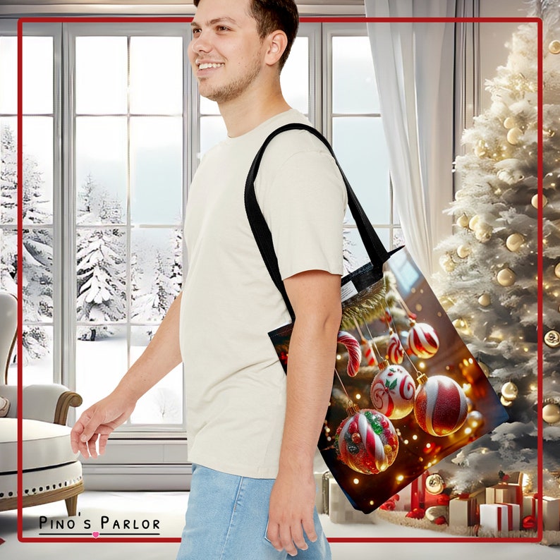 May include: A black tote bag with a Christmas-themed design featuring red and white ornaments, candy canes, and lights. The bag is being carried by a person in a white shirt and blue jeans.