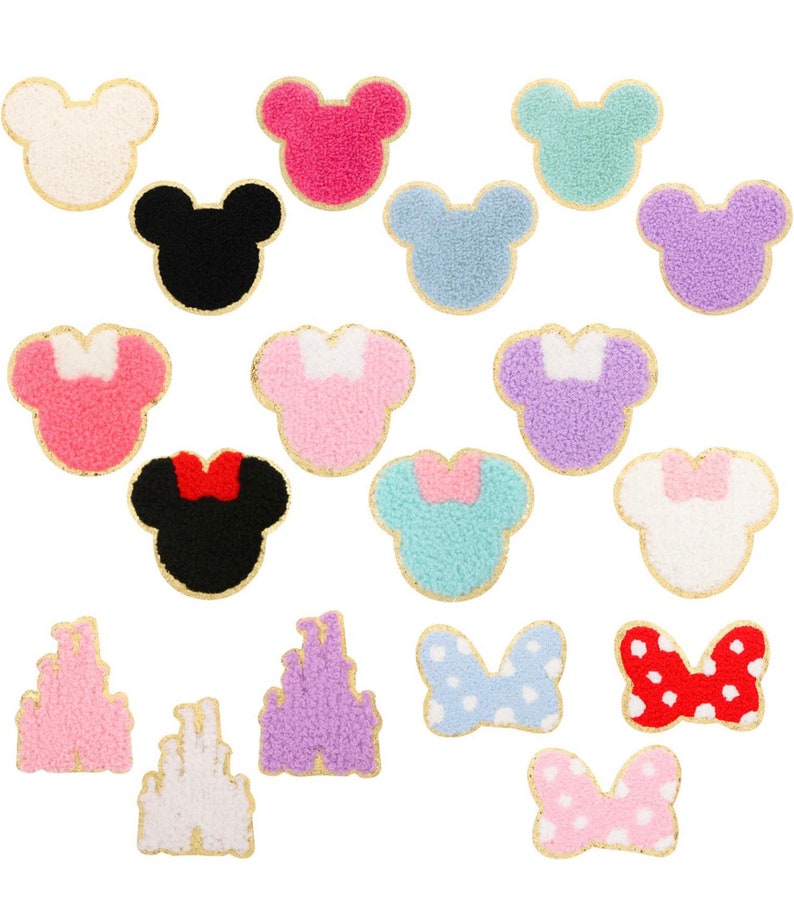 May include: A set of 18 iron-on patches featuring various Disney characters and symbols. The patches are made of fuzzy fabric and have a gold outline. The characters include Mickey Mouse, Minnie Mouse, and the Disney castle. The symbols include bows and hearts.