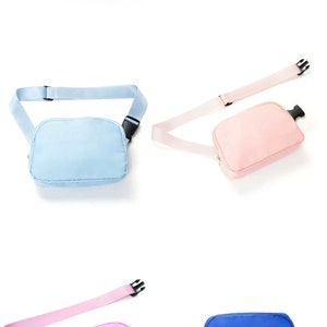 May include: Five different colored fanny packs with adjustable straps. The colors are pink, white, light blue, light pink, and blue.